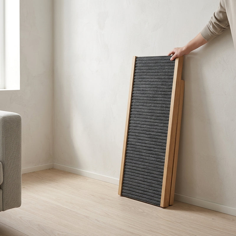 Wooden pet ramp stored upright against a living room wall